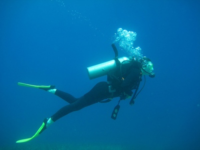 A scuba diver hovering under water